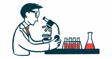 A researcher looks into a microscope.