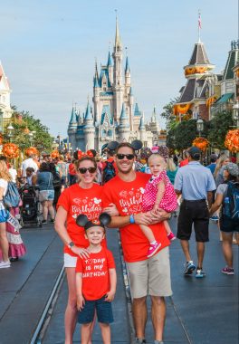 disease progression | Friedreich's Ataxia News | Dressed in orange T-shirts and Mickey Mouse hats, Kendall, her husband, daughter, and son pose in front of Disney's Magic Kingdom in 2019.