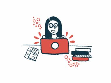 A woman working on a computer at a desk with papers and books nearby.