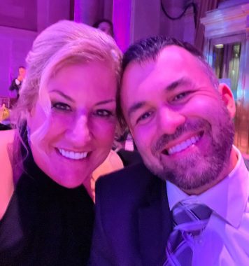 A close-up selfie of Jenn Powell and Matthew Lafleur at their dinner table at the MM+M Awards ceremony. Both are smiling broadly and elegantly dressed. 