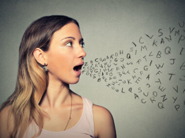 woman talking with randomized letters coming out of her mouth, illustrating speech