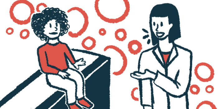 A child in a red shirt sits on an exam table, listening to a doctor in a white jacket.