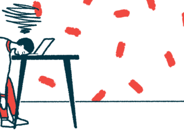 The acronym AAC is seen on the floor nearby a person seated at a table but sleeping on a laptop keyboard.